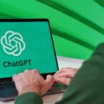 Person typing on a laptop displaying ChatGPT logo with a green vibrant setting.